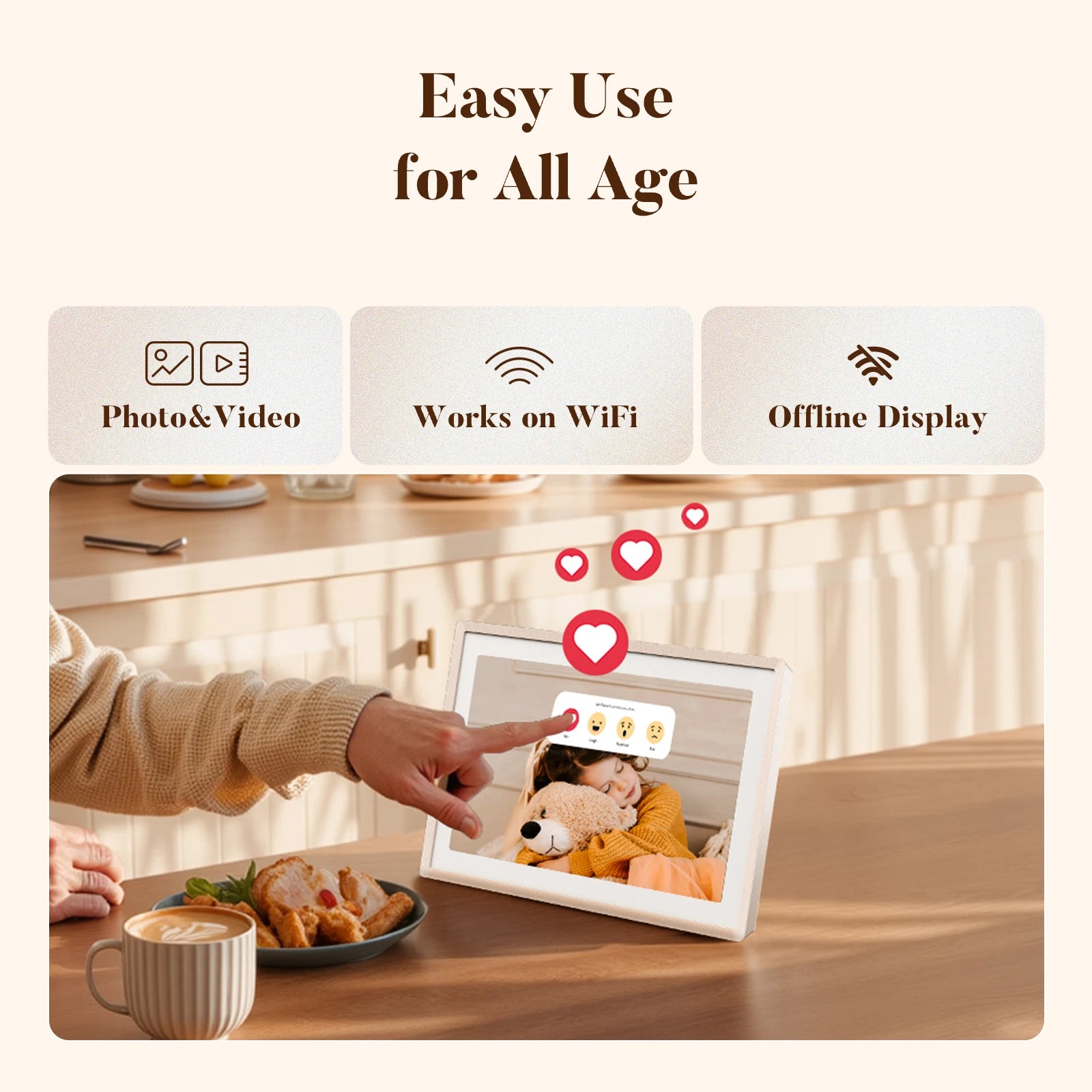 Hand tapping a sand 2K digital picture frame on a kitchen table showing a child hugging a teddy bear, with floating heart reactions