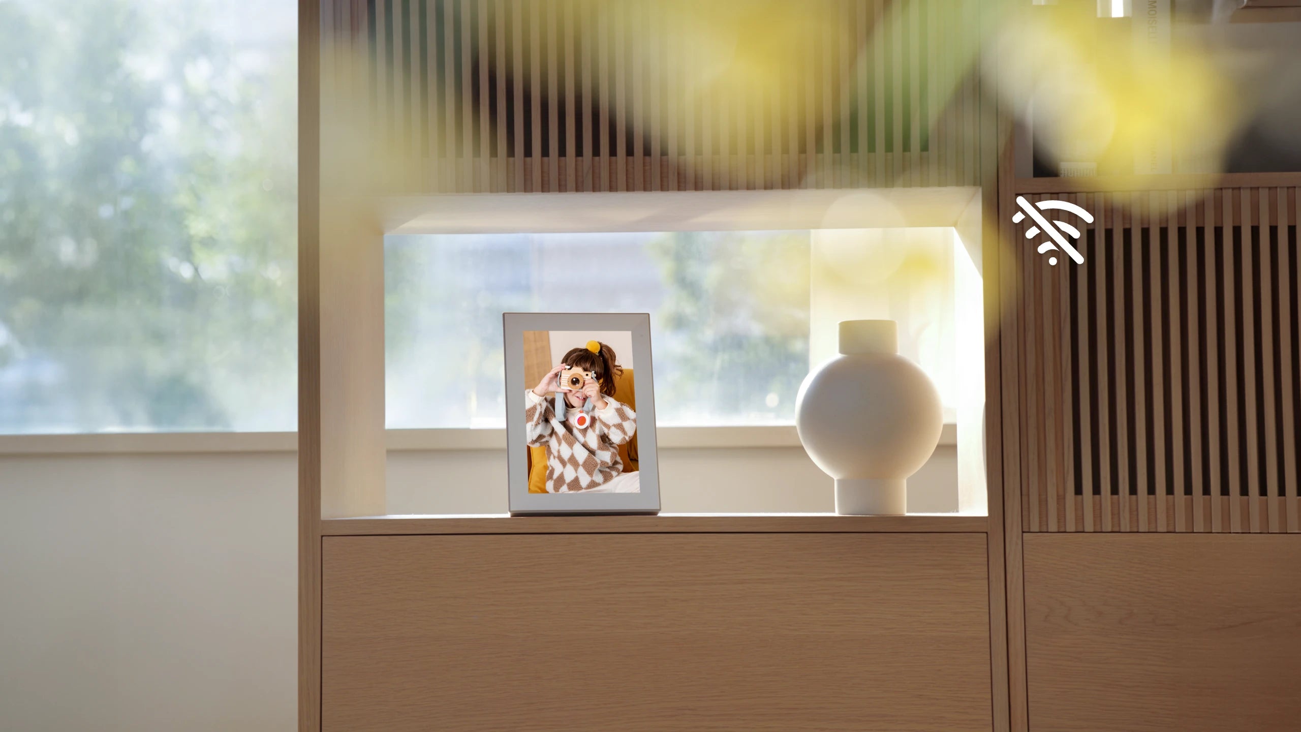 Modern interior with a wooden cabinet, pexar digital photo frame, and decorative items, pexar digital picture frames displays without WIFI.