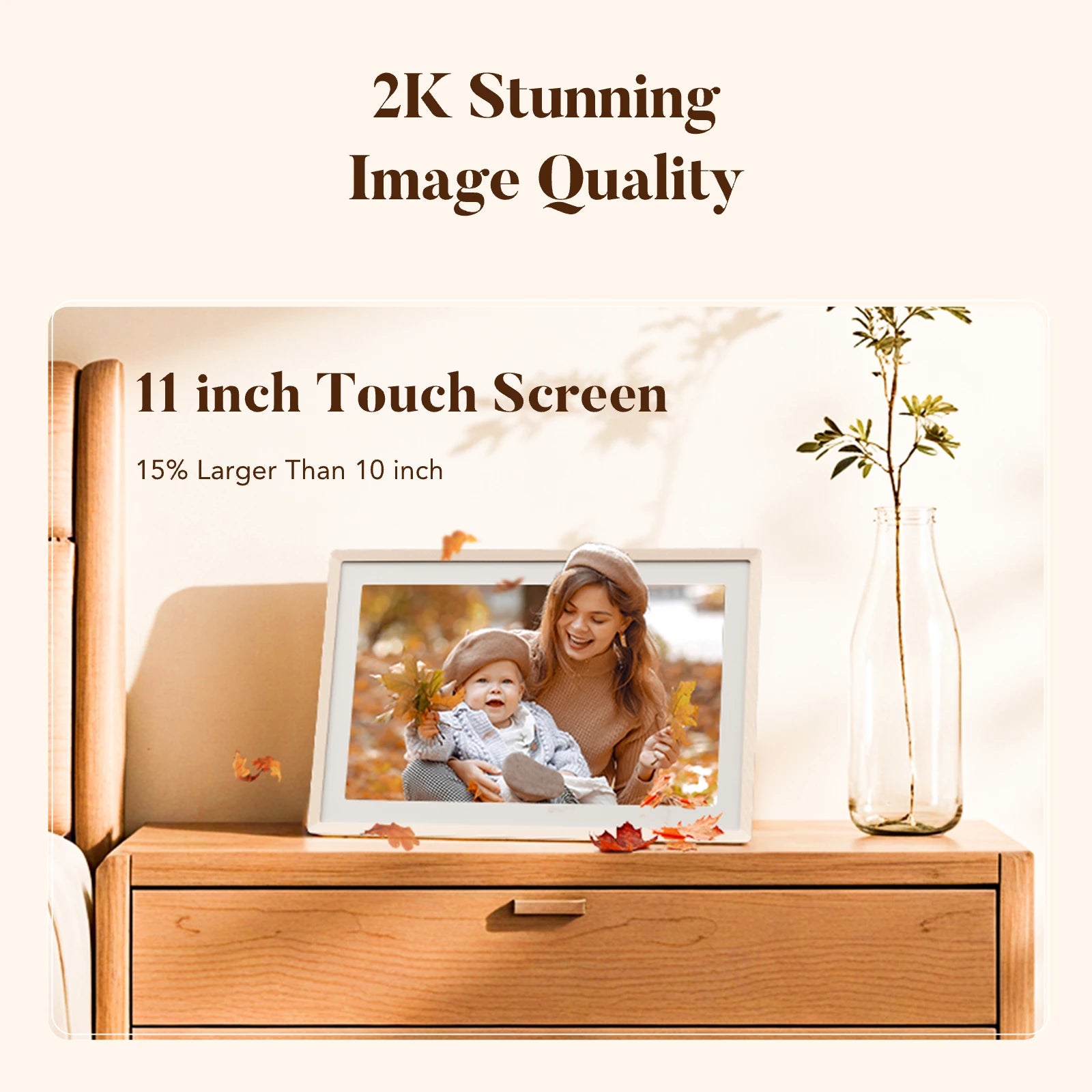 Sand 2K digital picture frame with 11-inch touch screen on a nightstand showing a mother and baby among autumn leaves
