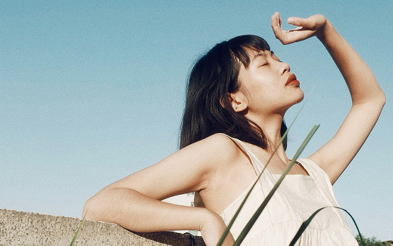 Woman with long hair against a clear blue sky