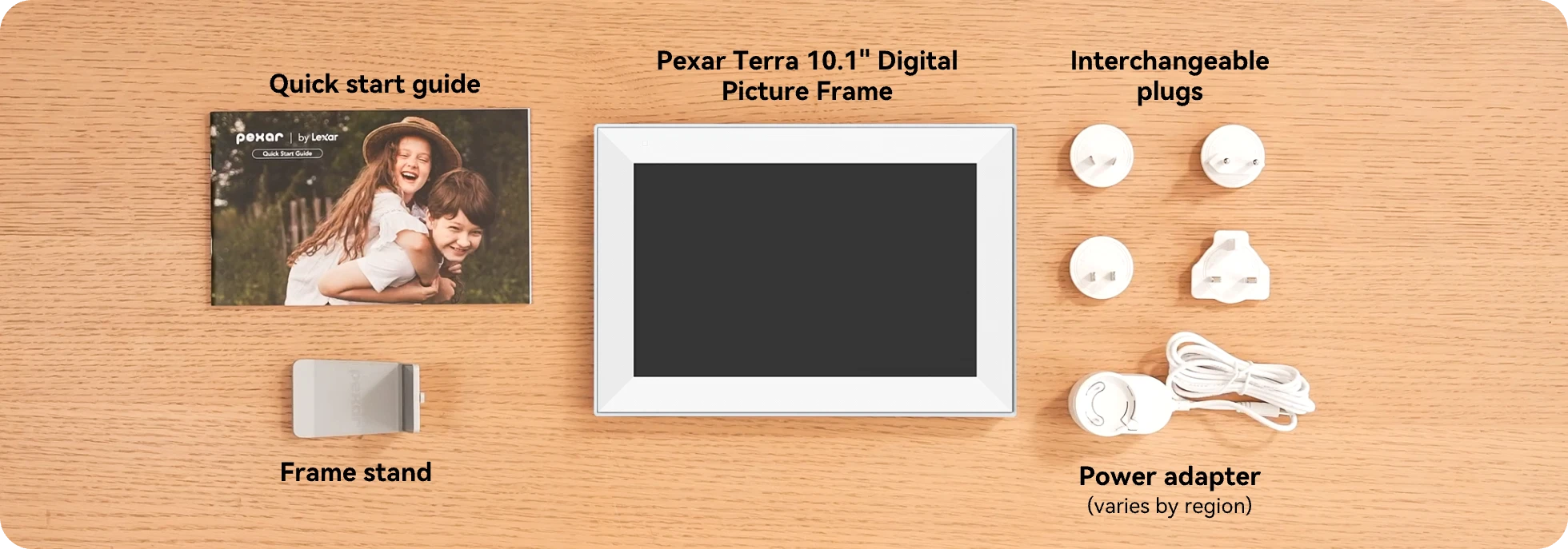 Pexar Terra 10.1" Digital Picture Frame with accessories on a wooden surface, pexar start guide, plugs, power adapter