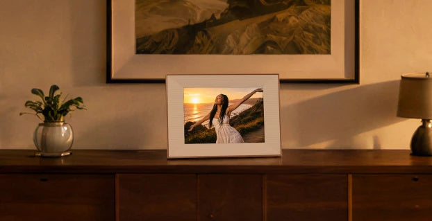 Frame on a sideboard below a framed landscape